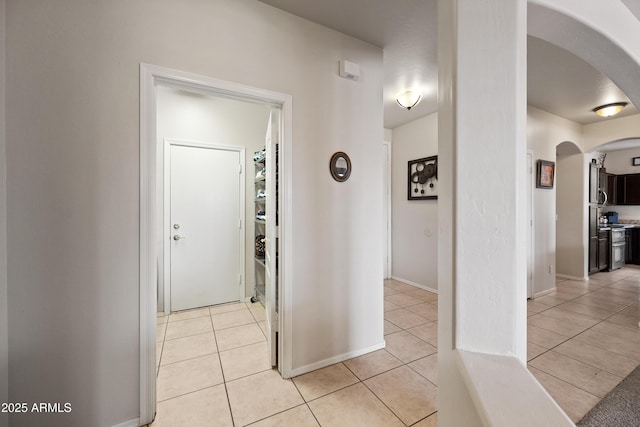 corridor with light tile patterned floors