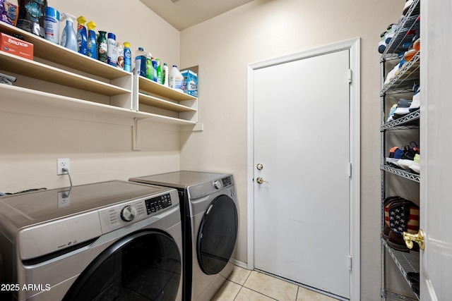 laundry area featuring separate washer and dryer and light tile patterned flooring