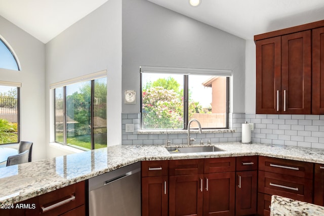 kitchen featuring dishwasher, a healthy amount of sunlight, vaulted ceiling, and sink