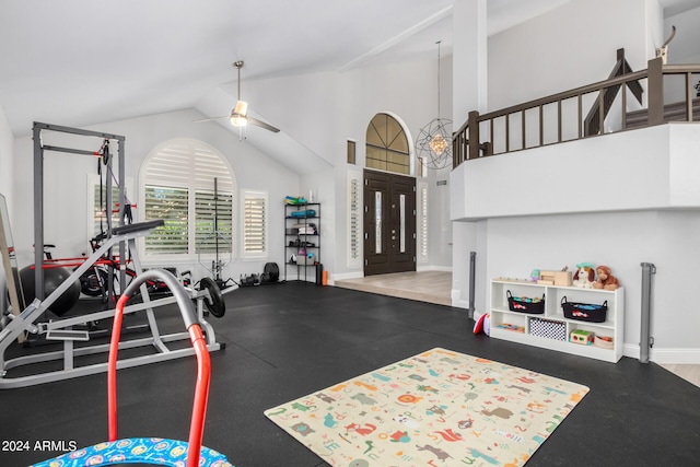 exercise room with high vaulted ceiling, ceiling fan, and hardwood / wood-style floors