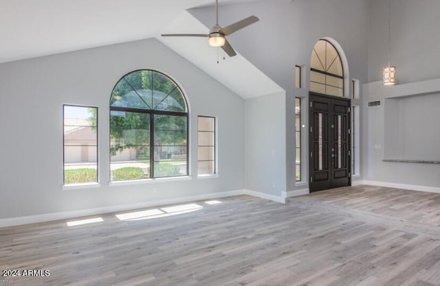 entrance foyer featuring a healthy amount of sunlight, ceiling fan, and light wood-type flooring