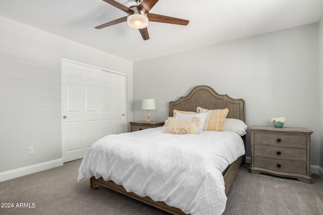 carpeted bedroom featuring ceiling fan and a closet