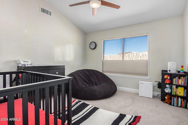 carpeted bedroom with ceiling fan and vaulted ceiling