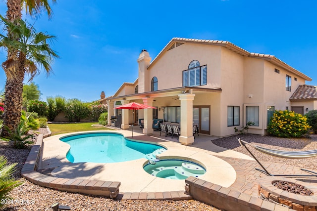 view of pool with a patio area and an in ground hot tub