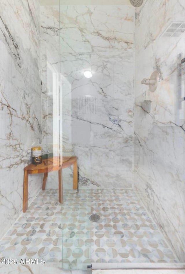 full bath featuring a marble finish shower