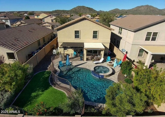 exterior space featuring a patio area, a mountain view, a fenced backyard, and stucco siding