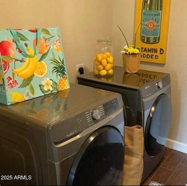 laundry room featuring baseboards, independent washer and dryer, wood tiled floor, and laundry area