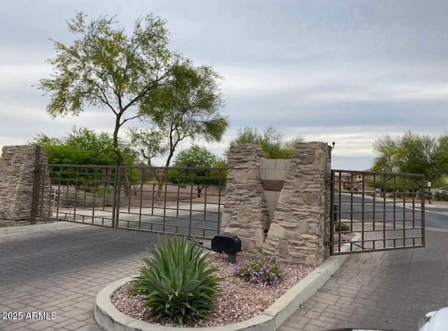 view of gate with fence