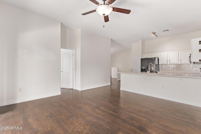 2250 E Deer Valley Rd Unit 26, Phoenix, AZ 85024 - unfurnished living room featuring lofted ceiling, ceiling fan, dark wood-style floors, and baseboards