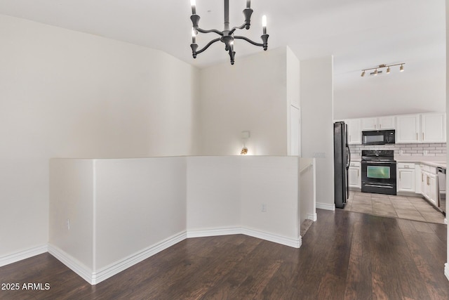 2250 E Deer Valley Rd Unit 26, Phoenix, AZ 85024 - kitchen with black appliances, a chandelier, light countertops, and wood finished floors