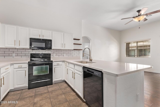 2250 E Deer Valley Rd Unit 26, Phoenix, AZ 85024 - kitchen featuring black appliances, a sink, a peninsula, open shelves, and decorative backsplash