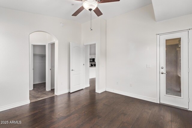 2250 E Deer Valley Rd Unit 26, Phoenix, AZ 85024 - unfurnished bedroom featuring arched walkways, wood finished floors, and baseboards