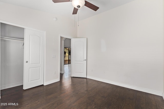 2250 E Deer Valley Rd Unit 26, Phoenix, AZ 85024 - unfurnished bedroom with baseboards, dark wood-type flooring, a closet, arched walkways, and ceiling fan
