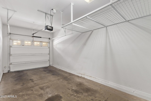 2250 E Deer Valley Rd Unit 26, Phoenix, AZ 85024 - garage featuring a garage door opener and baseboards