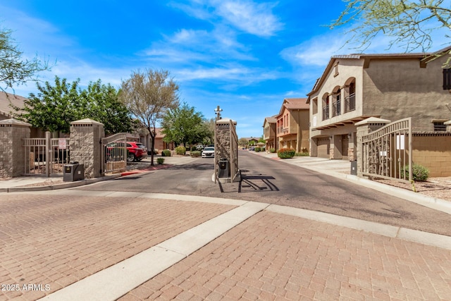 2250 E Deer Valley Rd Unit 26, Phoenix, AZ 85024 - view of asphalt street with a gate, a residential view, curbs, a gated entry, and sidewalks