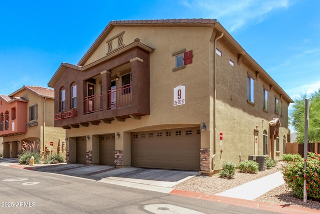 2250 E Deer Valley Rd Unit 26, Phoenix, AZ 85024 - view of building exterior featuring central AC unit, a garage, and concrete driveway