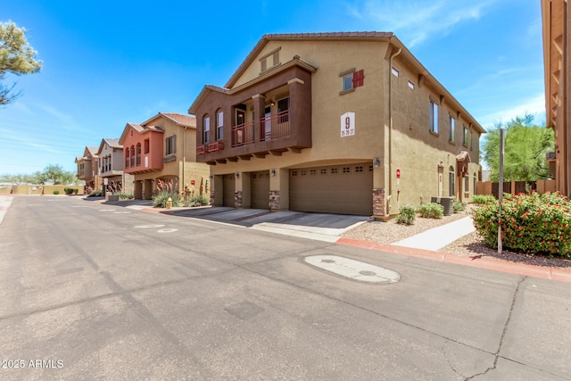 2250 E Deer Valley Rd Unit 26, Phoenix, AZ 85024 - view of property with central AC, a garage, and a residential view