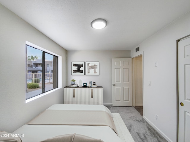 bedroom featuring light colored carpet