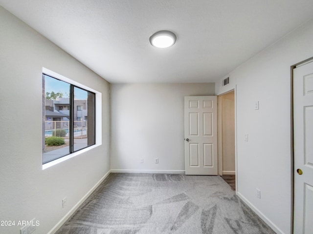 empty room with light colored carpet