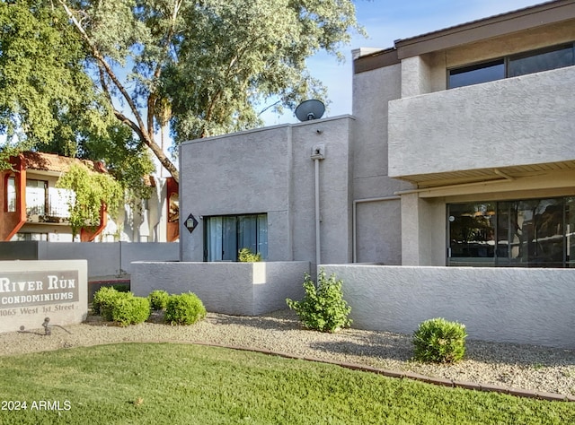 view of home's exterior with a fenced front yard and stucco siding