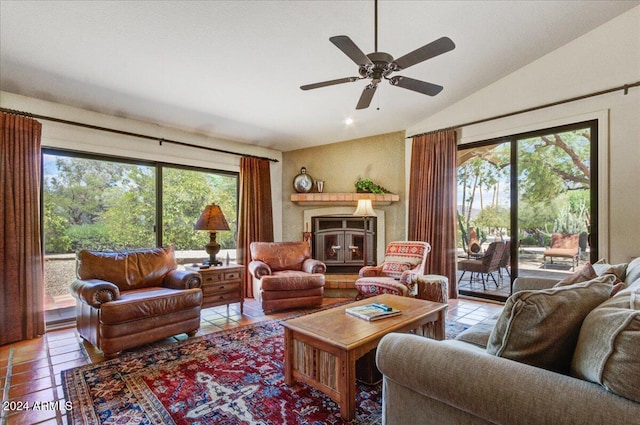 living room featuring a wealth of natural light, light tile patterned flooring, vaulted ceiling, and ceiling fan