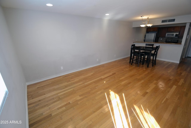 4120 N 78th St Unit 116, Scottsdale, AZ 85251 - dining area featuring a chandelier, light wood finished floors, baseboards, and recessed lighting