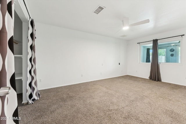spare room with carpet flooring, a ceiling fan, and baseboards