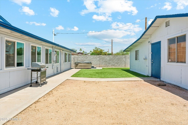 view of yard with a hot tub and a patio