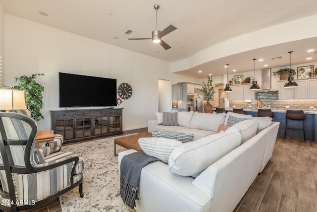 living room with wood-type flooring and ceiling fan