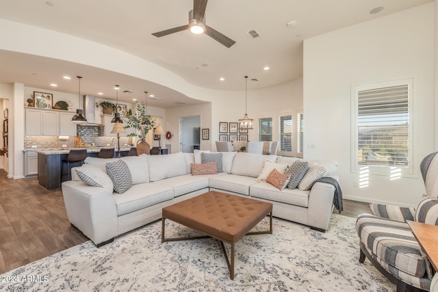 living room with ceiling fan and light hardwood / wood-style floors