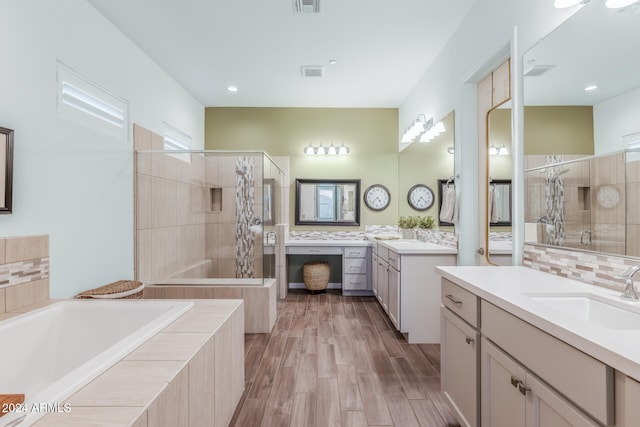 bathroom featuring hardwood / wood-style floors, vanity, plenty of natural light, and shower with separate bathtub