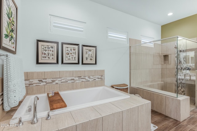 bathroom with hardwood / wood-style floors and plus walk in shower