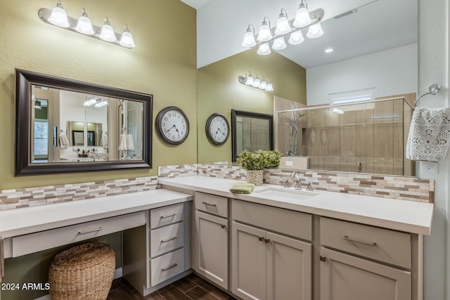 bathroom with tasteful backsplash, vanity, wood-type flooring, and an enclosed shower