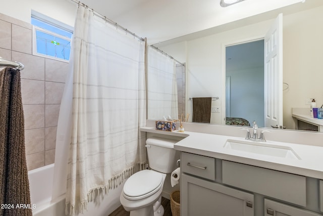 full bathroom featuring toilet, vanity, and shower / tub combo with curtain