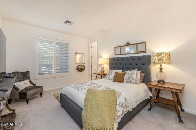 bedroom featuring multiple windows and carpet