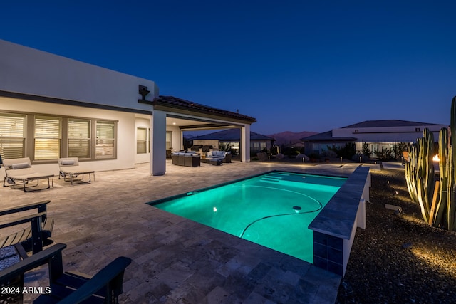 view of pool featuring an outdoor living space and a patio