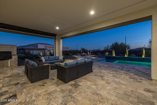 view of patio with an outdoor living space with a fireplace