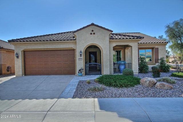 mediterranean / spanish home featuring a garage