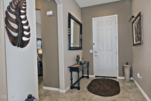 foyer entrance featuring light tile patterned flooring