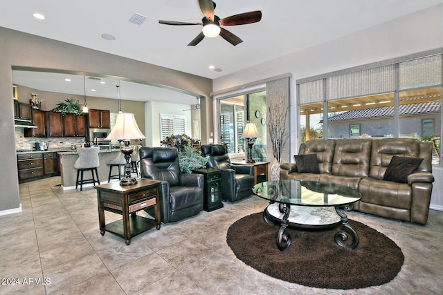 tiled living room with ceiling fan