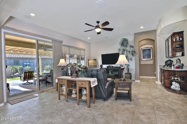 living room with light tile patterned floors and ceiling fan