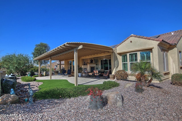 back of house featuring a pergola, a patio area, and a lawn