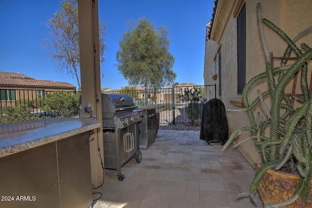 view of patio / terrace featuring a grill and exterior kitchen