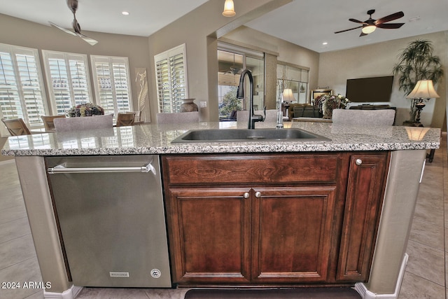 kitchen featuring dishwasher, sink, ceiling fan, light tile patterned flooring, and light stone counters