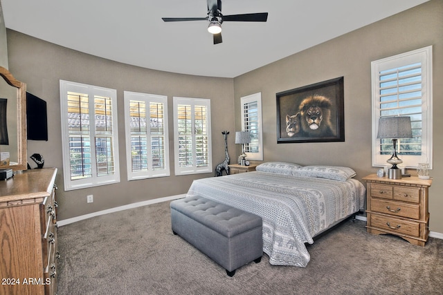 carpeted bedroom featuring multiple windows and ceiling fan