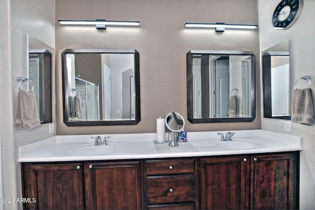 bathroom featuring vanity and a shower with shower door