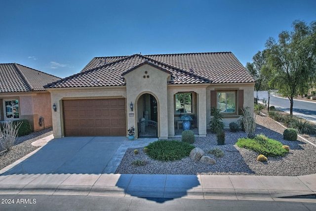 mediterranean / spanish house with a garage