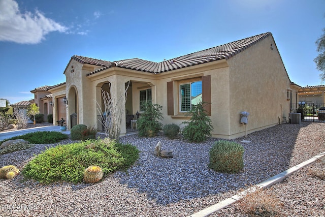 view of property exterior with a garage and cooling unit