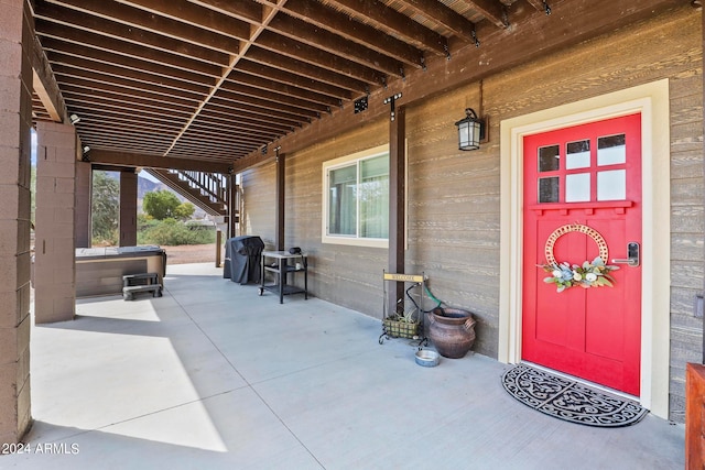 exterior space featuring a patio and a hot tub