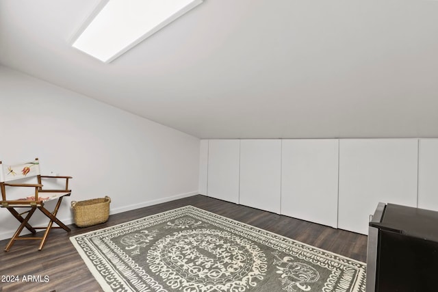 additional living space featuring dark hardwood / wood-style floors and vaulted ceiling